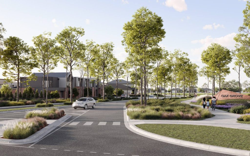 A tree-lined street in a modern suburban neighborhood with a person walking on the sidewalk.